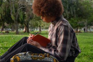 photo of woman writing on notebook